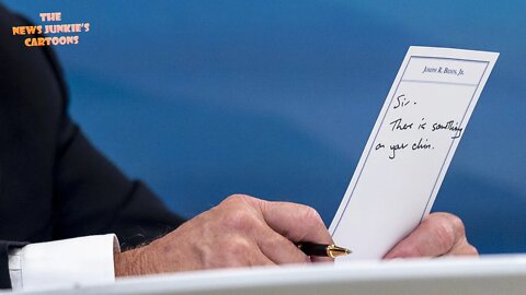 A staffer hands Biden a note: "Sir, there is something on your chin."