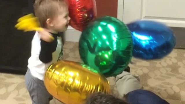 Toddler super excited to bang around balloons!