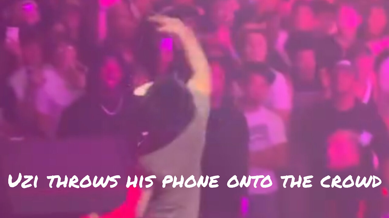 Uzi throws his phone onto the crowd while performing