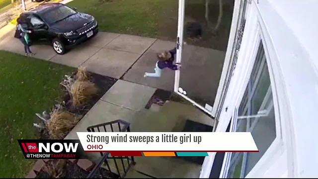 Surveillance video captures girl being blown away by high winds