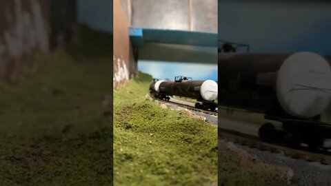 N Scale tank train descending a hill with dynamics screaming