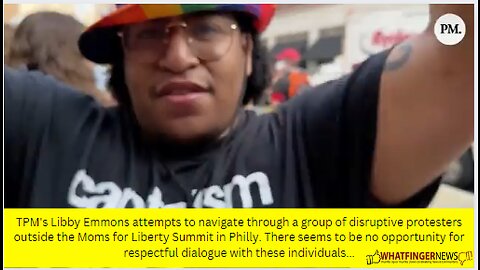 TPM's Libby Emmons attempts to navigate through a group of disruptive protesters outside