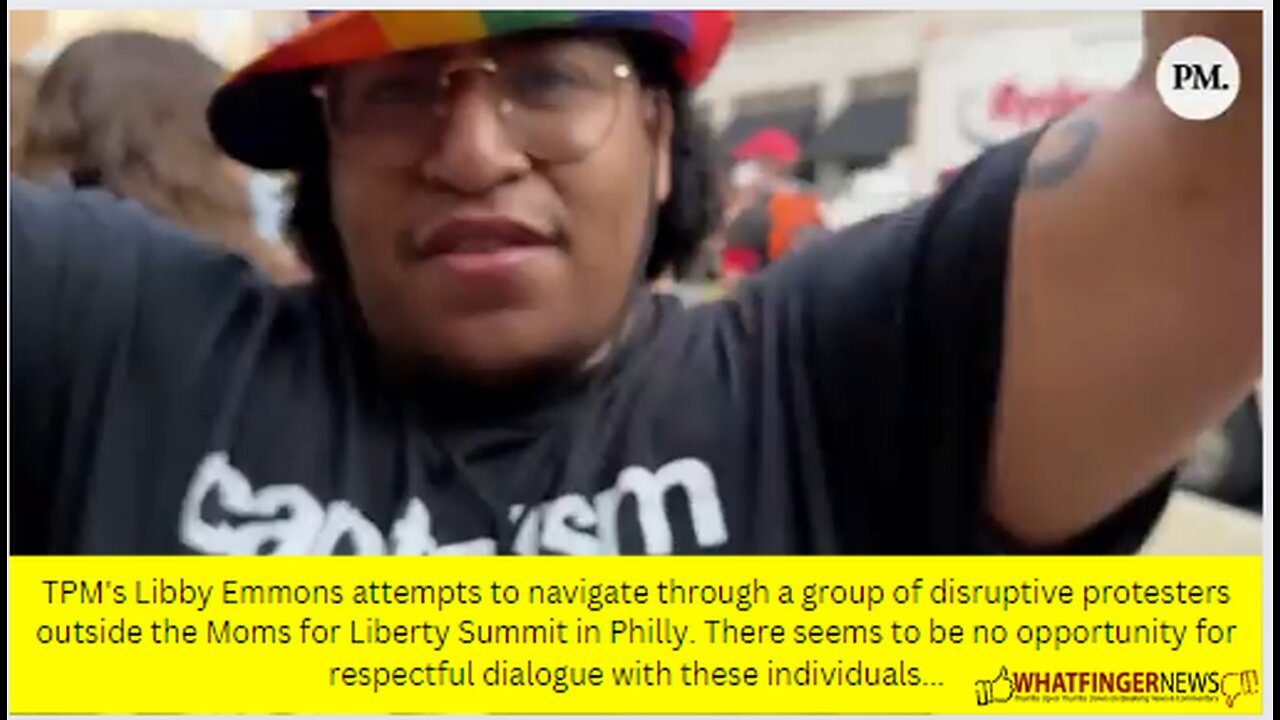 TPM's Libby Emmons attempts to navigate through a group of disruptive protesters outside