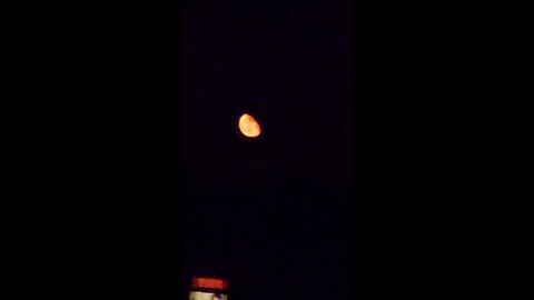 Huge Moon, that's the color of a construction Barrel