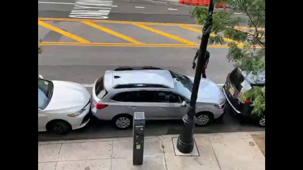 Skilled driver expertly removes car from A tight parking Space