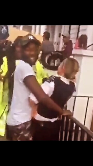 2018: Black dudes on British female police officer. Notting Hill Carnival, London.