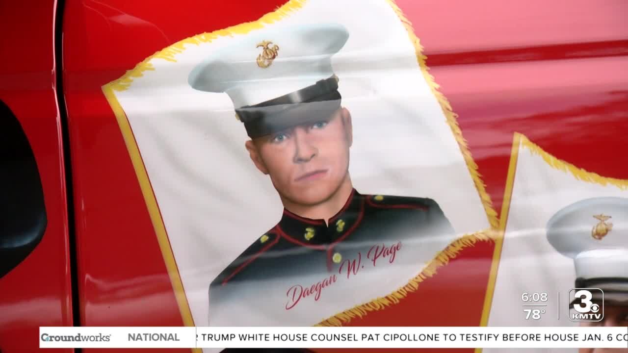 A mobile mural honoring 13 fallen marines, including Daegan Page, is unveiled in Omaha