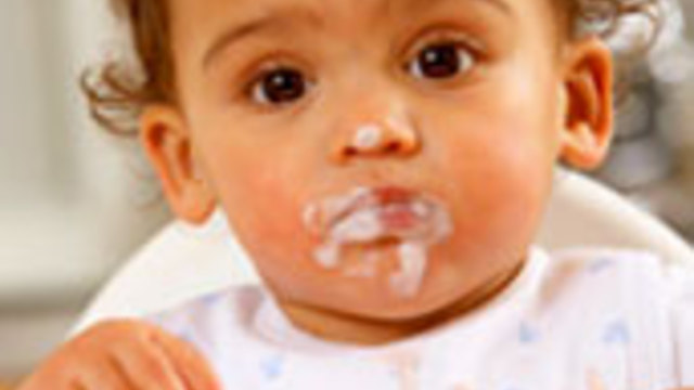 Baby fills his face with his mom's delicious food.