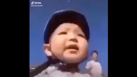 Asian kid falls off bike