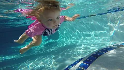 Swimming babies float and dive for rings