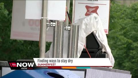 Patrons find ways to stay dry during soggy Summerfest opener