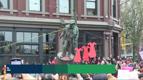 Vancouver’s Women’s Memorial March tears down a statue of John Deighton, “Gassy Jack” in Gastown