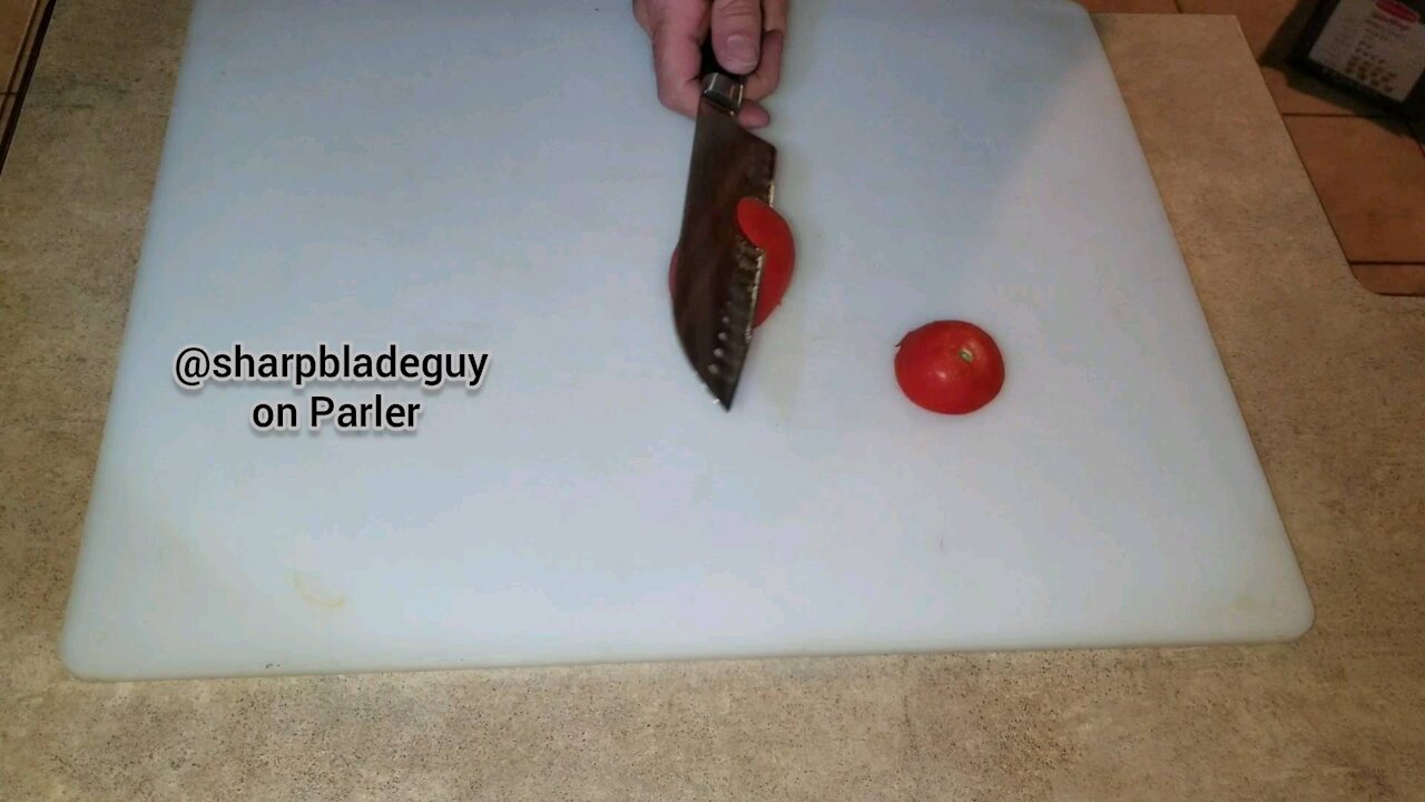 Slicing a tomato without holding it.