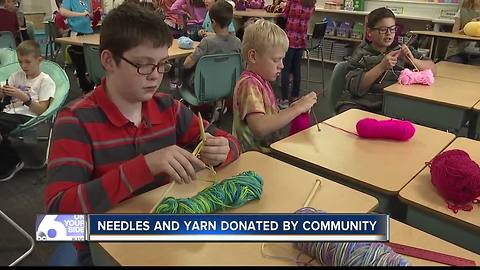 Fifth-graders knit scarves for the homeless