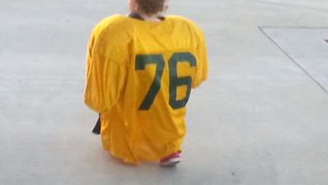 A Tot Boy Hilariously Wearing A Football Jersey