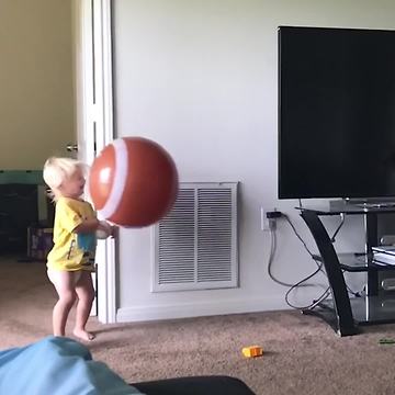 Toddler Falls On The Ground When Hit With A Huge Ball