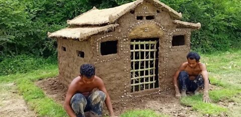 Construction of a wooden house from clay.