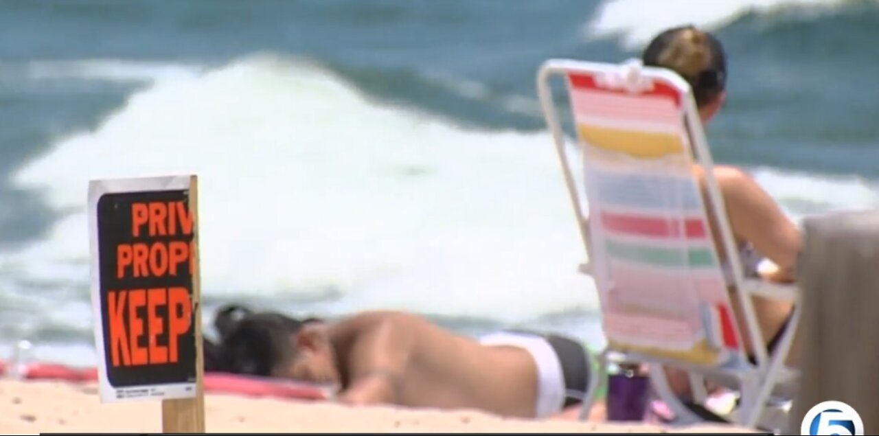 Private property signs up at beach