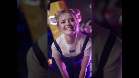 Beautiful Teenage Girl Kissing in Amusement Park