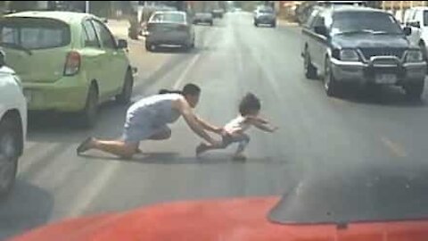 Mom jumps into busy road to save daughter