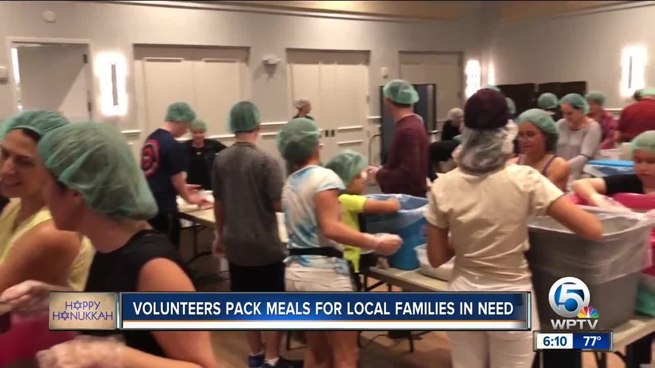 Volunteers pack 80,000 meals for families in need
