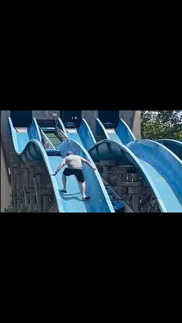Dad climbs up waterslide to rescue stuck daughter
