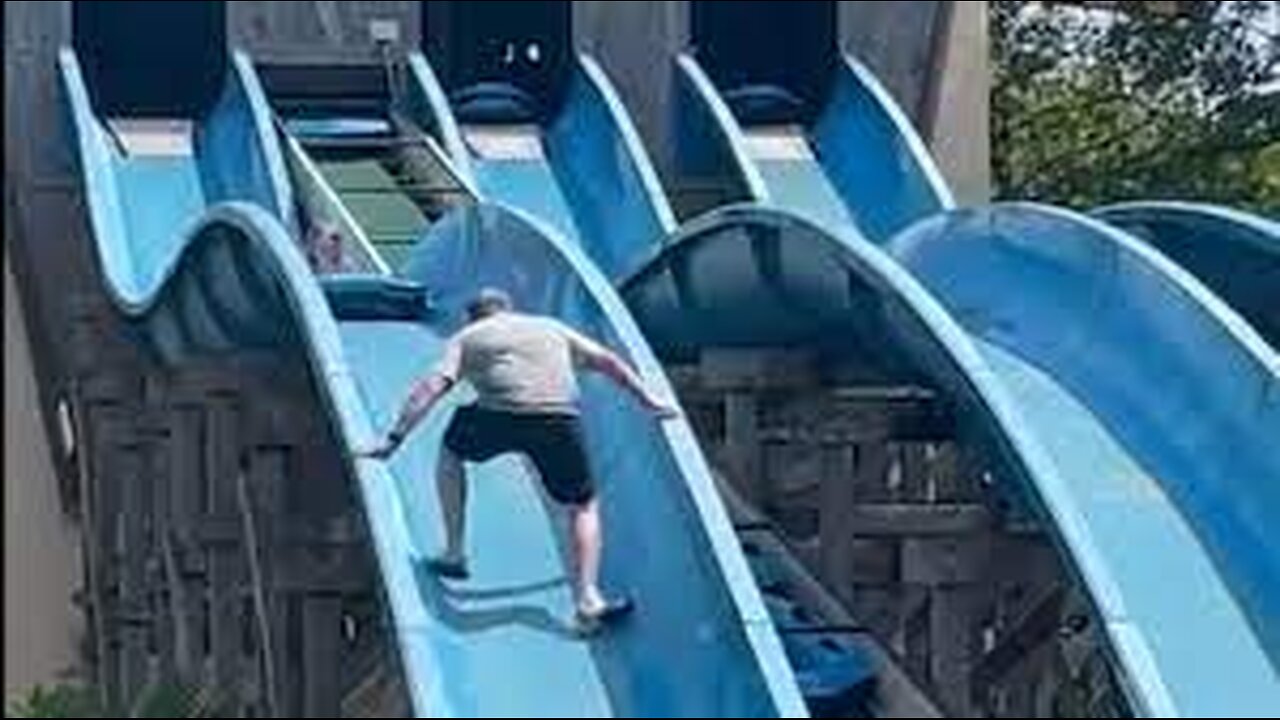 Dad climbs up waterslide to rescue stuck daughter