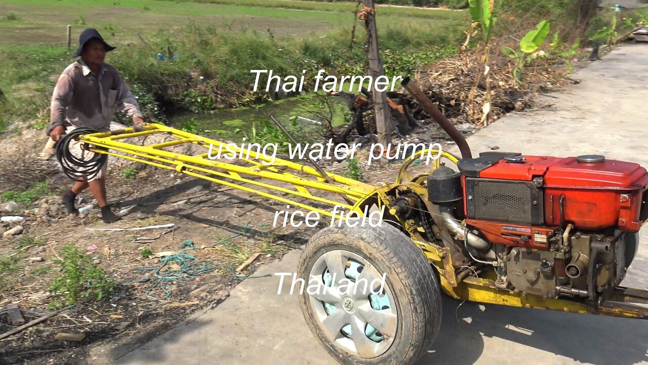 Thai farmer use irrigation water pump at rice field in Thailand