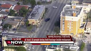 At least 10 people being held hostage