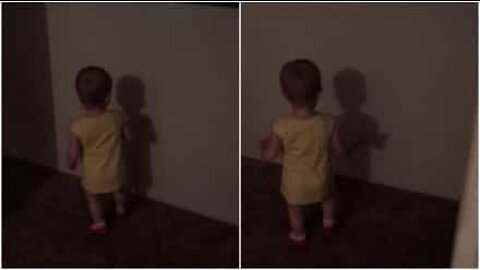 Cute baby puzzled by her own shadow