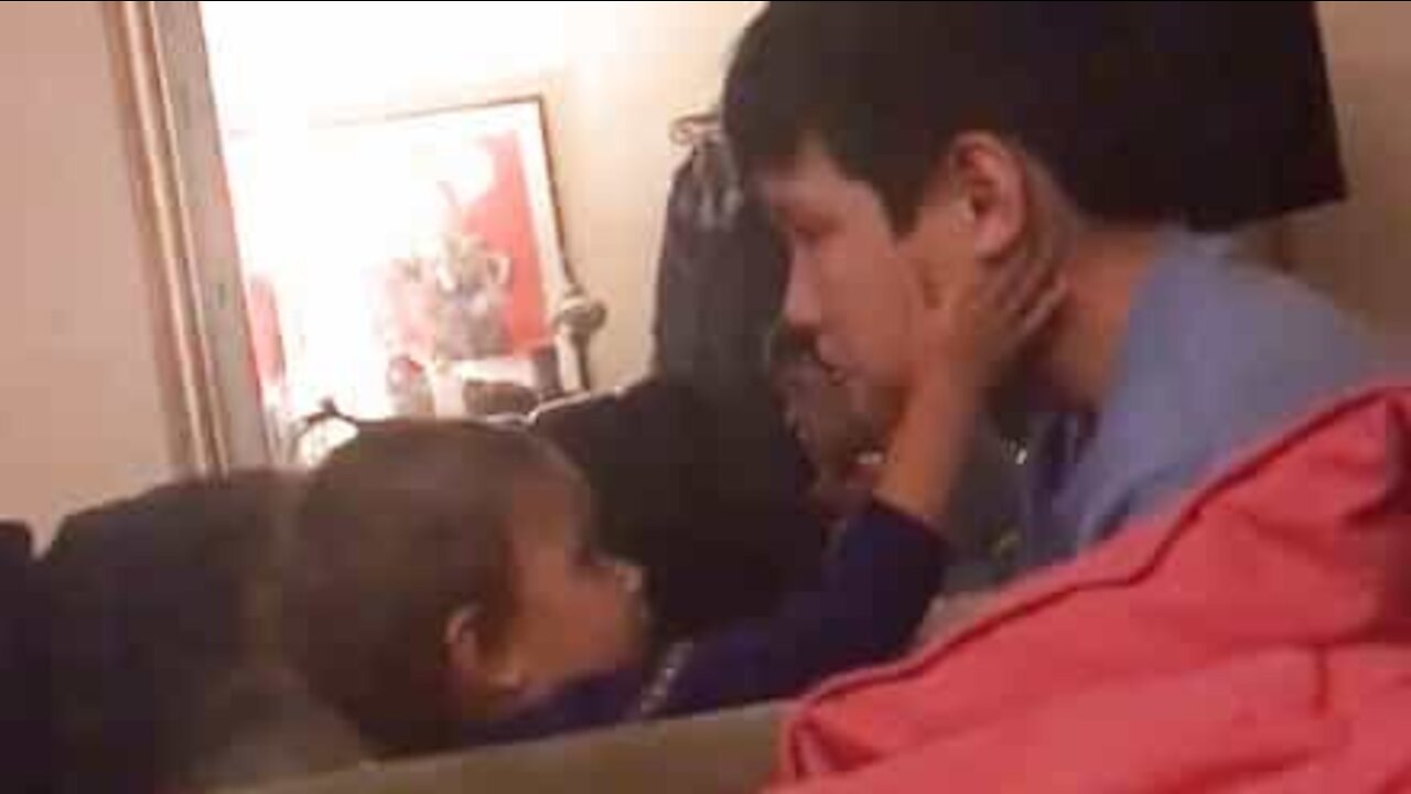 Baby sister comforts older brother during emotional movie