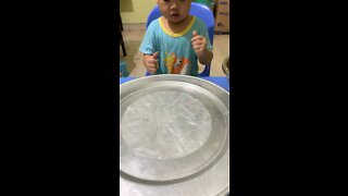 Baby helps mom roll spring rolls