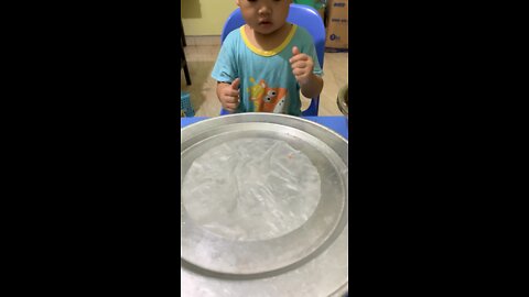 Baby helps mom roll spring rolls