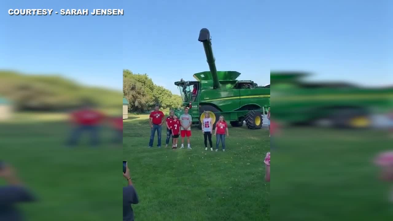 Daughter surprises parents with gender reveal using combine