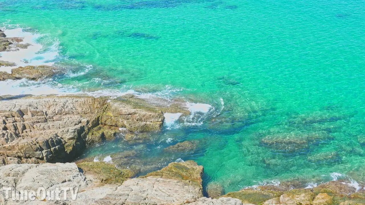 Amazing Tropical Blue Waves Breaching Rocks In The Sea