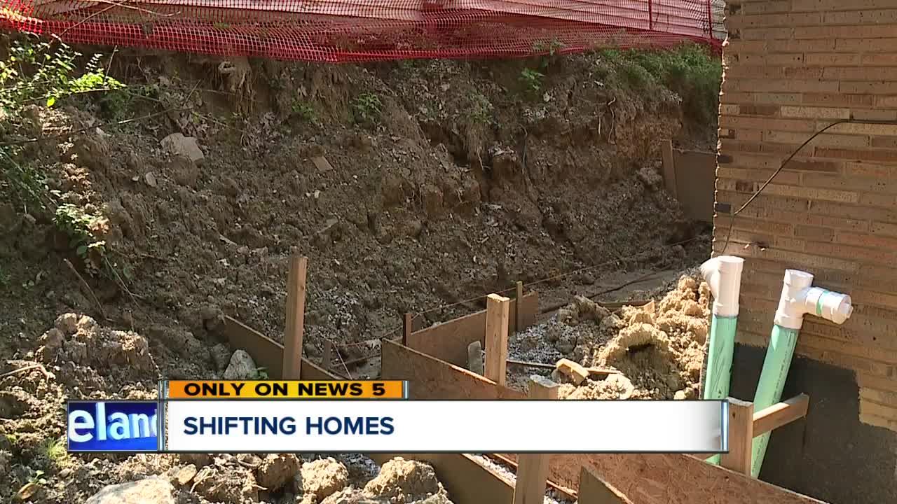 Work to fix housing code violations is left unfinished after removing a retaining wall