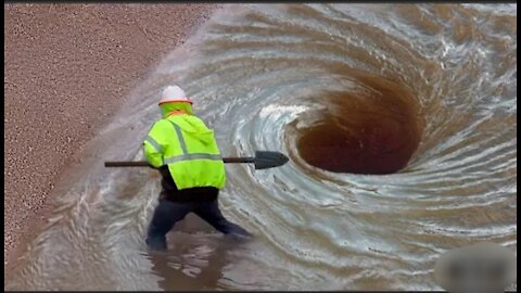 Worker unlogy drain as highway 288 floods