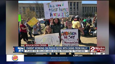 Tulsa parent working on photo book with signs of education rally