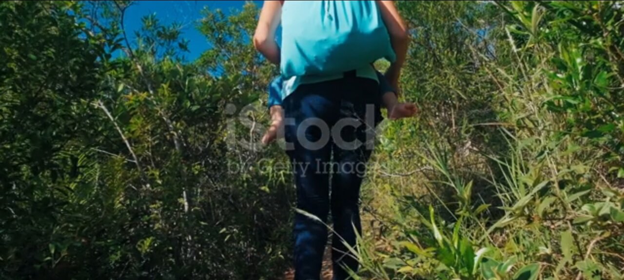 Woman walk with baby in jungle