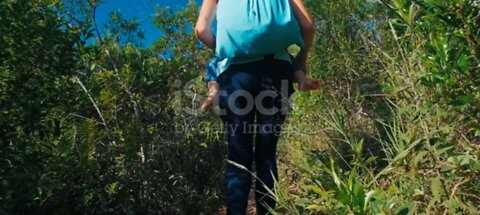 Woman walk with baby in jungle