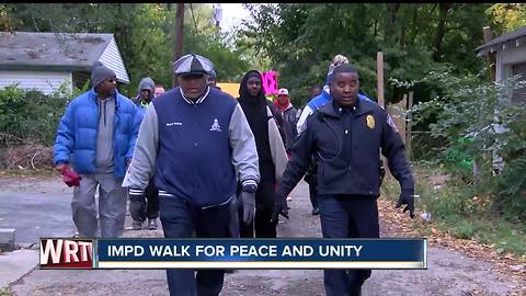 Police officers and church leaders hold a walk aimed at uniting people and keeping the peace