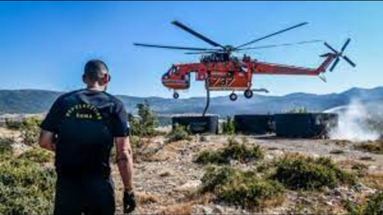 Moments of refueling firefighting helicopters with water. Greek widlfire rages near Athens