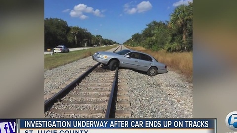 Investigation underway after car ends up on tracks