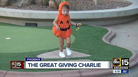 Valley toddler handing out "boo baskets"