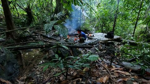 Building a bamboo shelter on a rock face:6