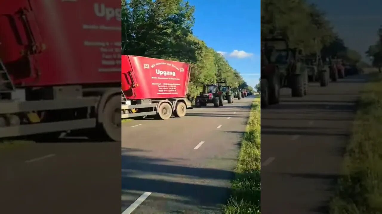 Handshake and exchange of banners between German and Dutch farmers