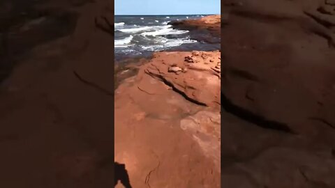 Climbing along the rocks at the beach