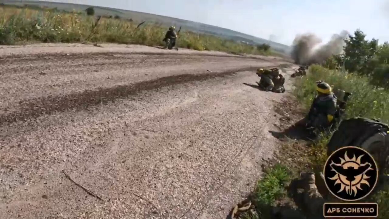 Ukrainian soldiers retreat after coming under fire from Russian forces in the Zaporizhzhia region