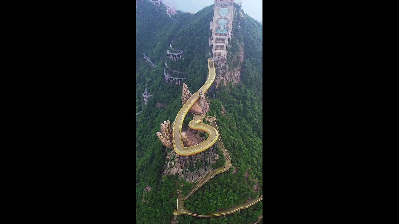A golden corridor bridge with Buddha's hand on the Ma Ling Tian Guan Natural Scenic Area