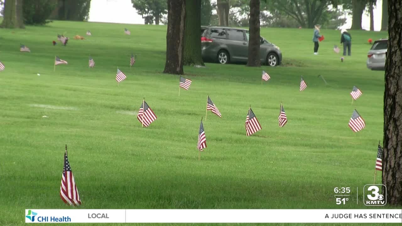 Volunteers place more than 8,600 flags at veteran gravesites